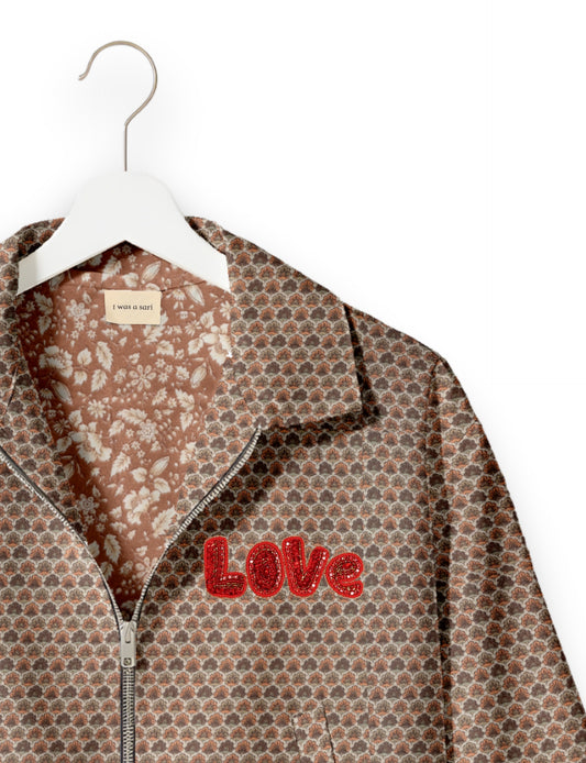 Love Bomber Jacket made from recycled fabric, featuring hand-stitched Aari embroidery. A unique piece of zero-waste clothing, part of the circular fashion movement. Designed with upcycled materials for a stylish yet environmentally friendly clothing choice.