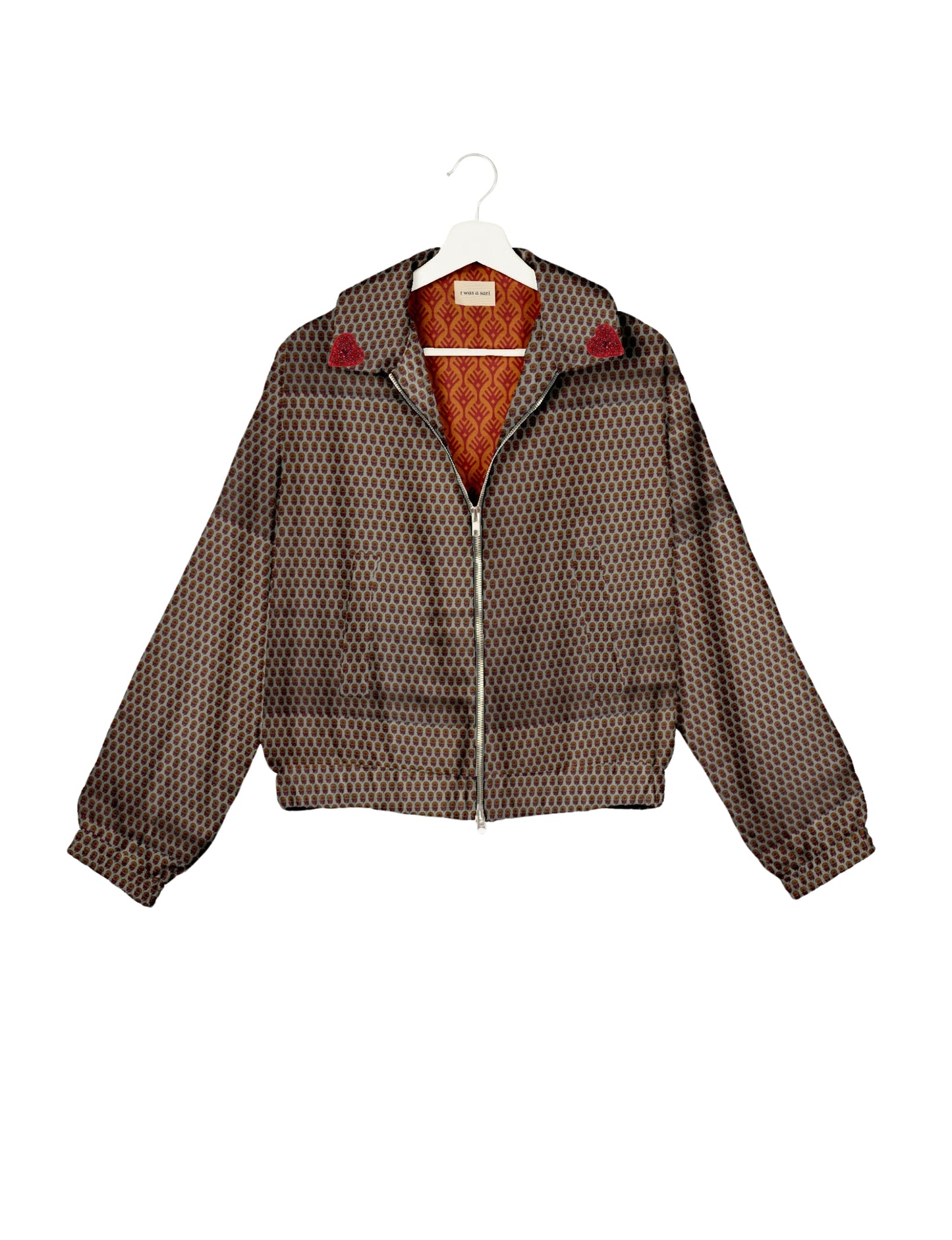 Make a bold statement with our Heart Drop Earrings, a symbol of conscious luxury and ethical fashion. Handcrafted using the intricate Aari embroidery technique, these earrings are made from upcycled sari fabric, embracing slow fashion and zero waste clothing. Elevate your look with sustainable apparel that supports fair trade fashion while reducing textile waste. Choose eco-friendly fashion that speaks of love, artistry, and responsibility.