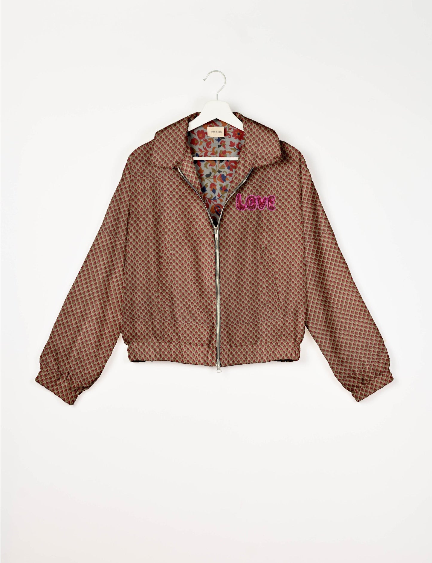 Love Bomber Jacket made from recycled fabric, featuring hand-stitched Aari embroidery. A unique piece of zero-waste clothing, part of the circular fashion movement. Designed with upcycled materials for a stylish yet environmentally friendly clothing choice.