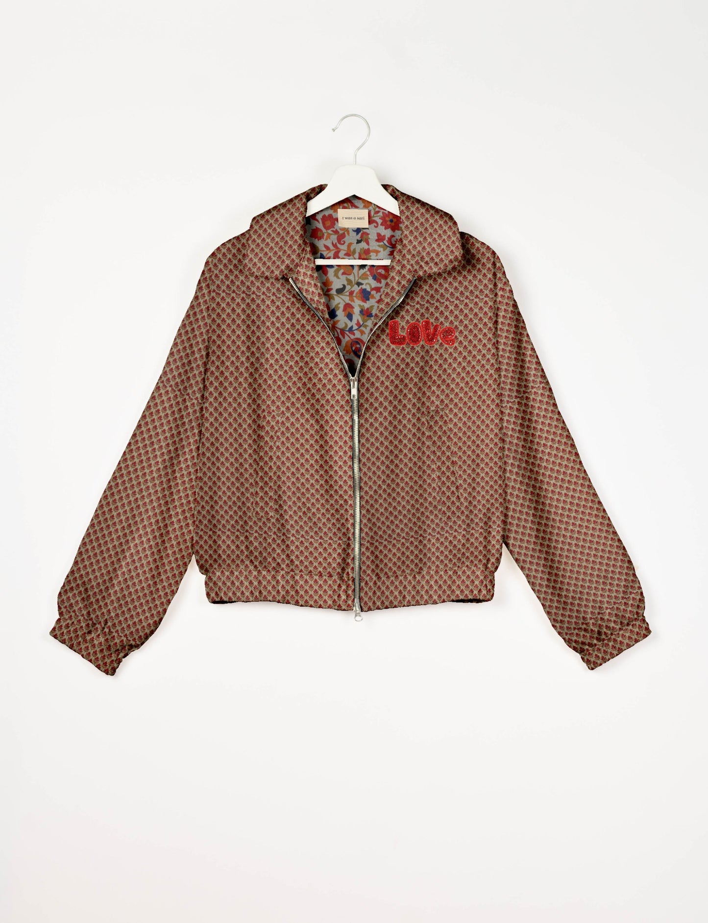 Love Bomber Jacket made from recycled fabric, featuring hand-stitched Aari embroidery. A unique piece of zero-waste clothing, part of the circular fashion movement. Designed with upcycled materials for a stylish yet environmentally friendly clothing choice.