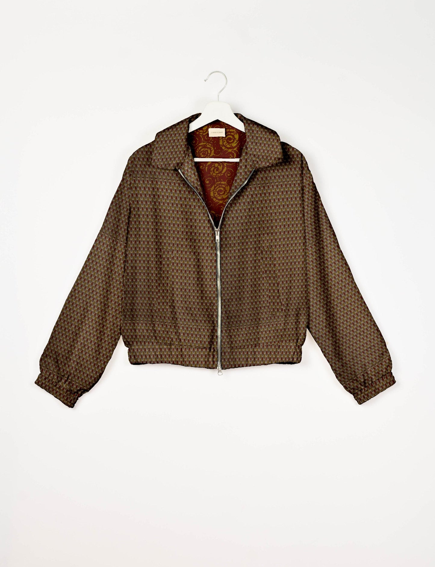 Upcycled Bomber Jacket made from recycled sari materials, featuring a cute cropped shape, elasticated hem and cuffs, and contrast sari print lining. Sustainable apparel promoting eco-friendly fashion and ethical clothing.