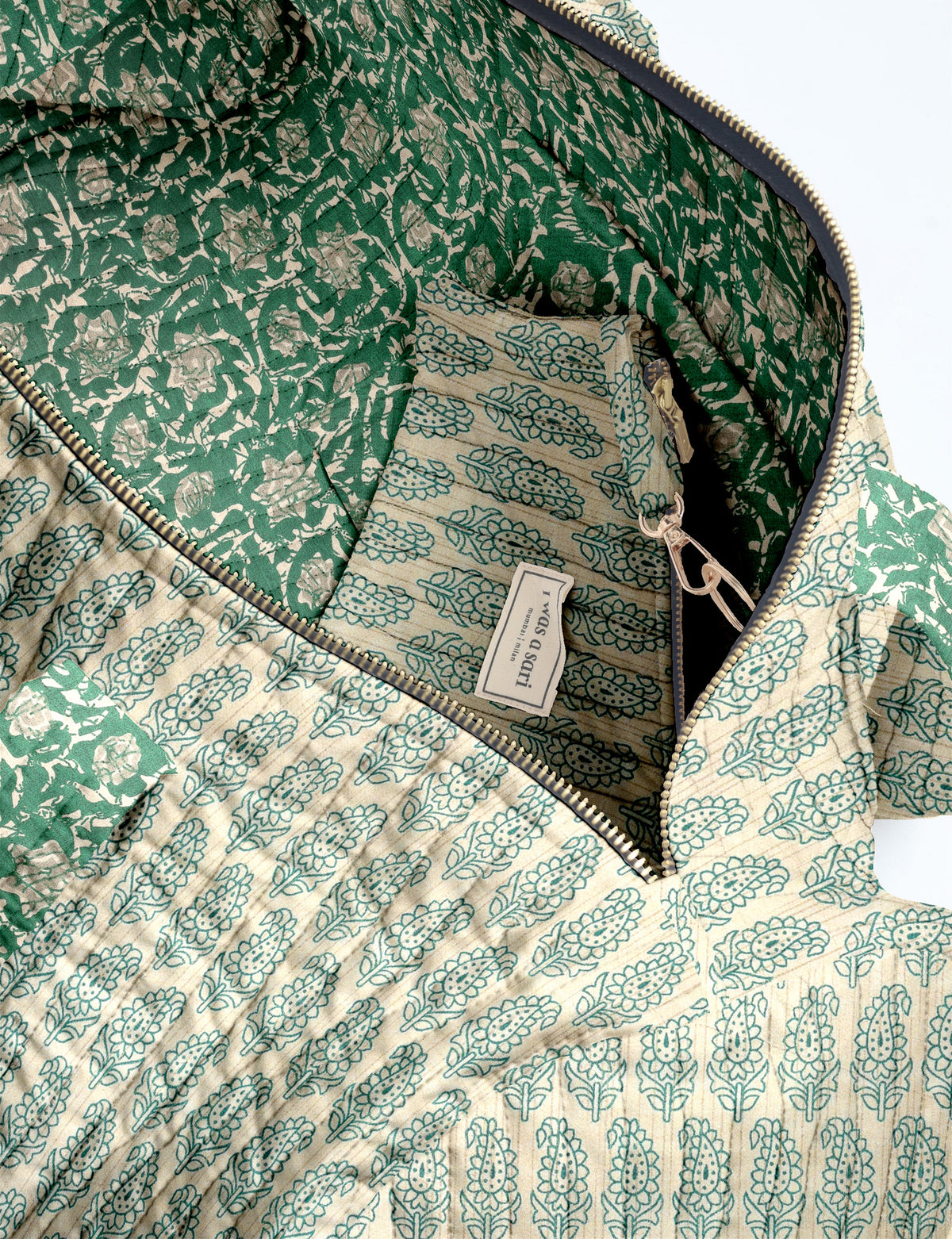 Brown paisley quilted bowling bag with dual handles, front zipper pocket, and "I was a sari" label on front side