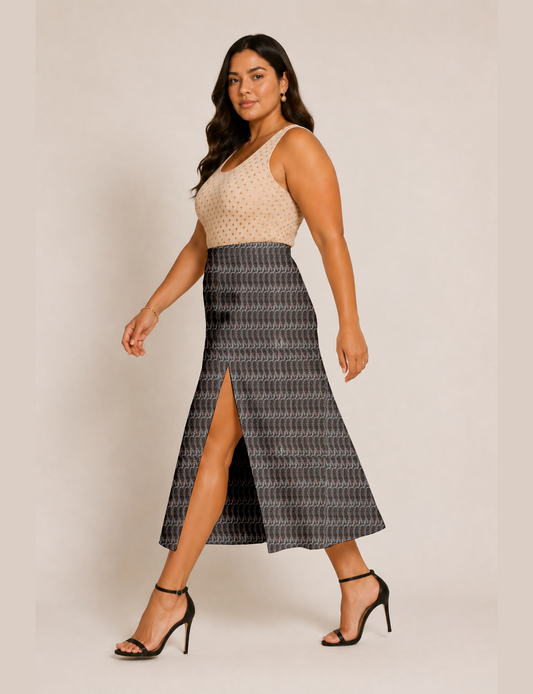 Woman wearing a yellow and black micro patterned A-line skirt with front slit, paired with beige sleeveless top and black