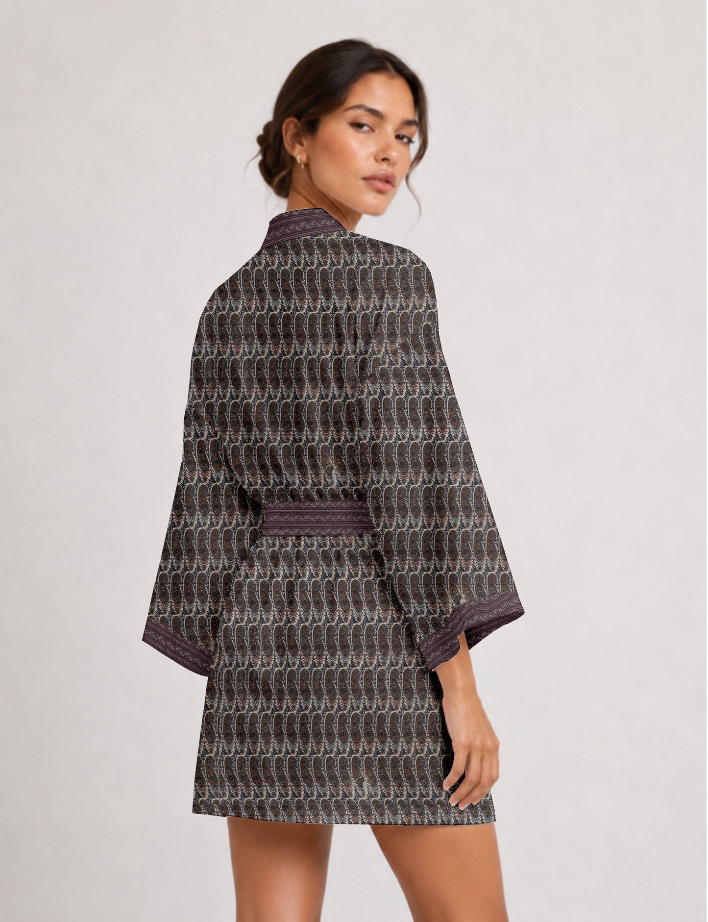 Short kimono robe with wrap front, V-neckline, wide sleeves, waist tie, and concealed skort detail.