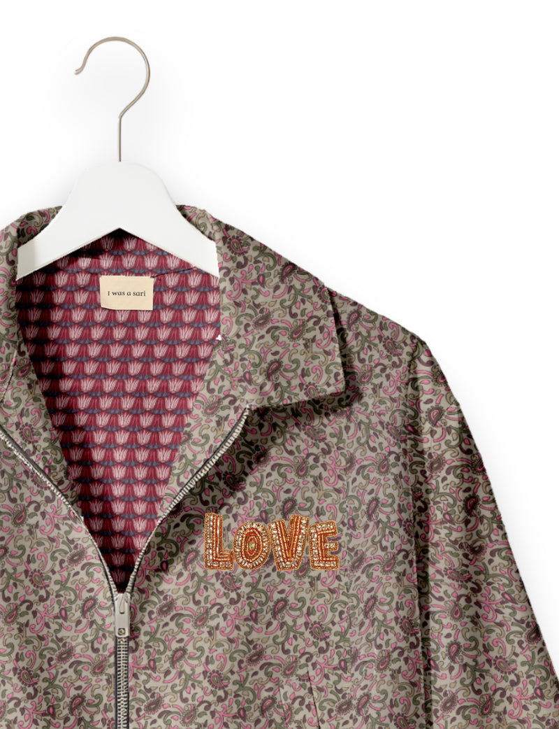 Love Bomber Jacket made from recycled fabric, featuring hand-stitched Aari embroidery. A unique piece of zero-waste clothing, part of the circular fashion movement. Designed with upcycled materials for a stylish yet environmentally friendly clothing choice.