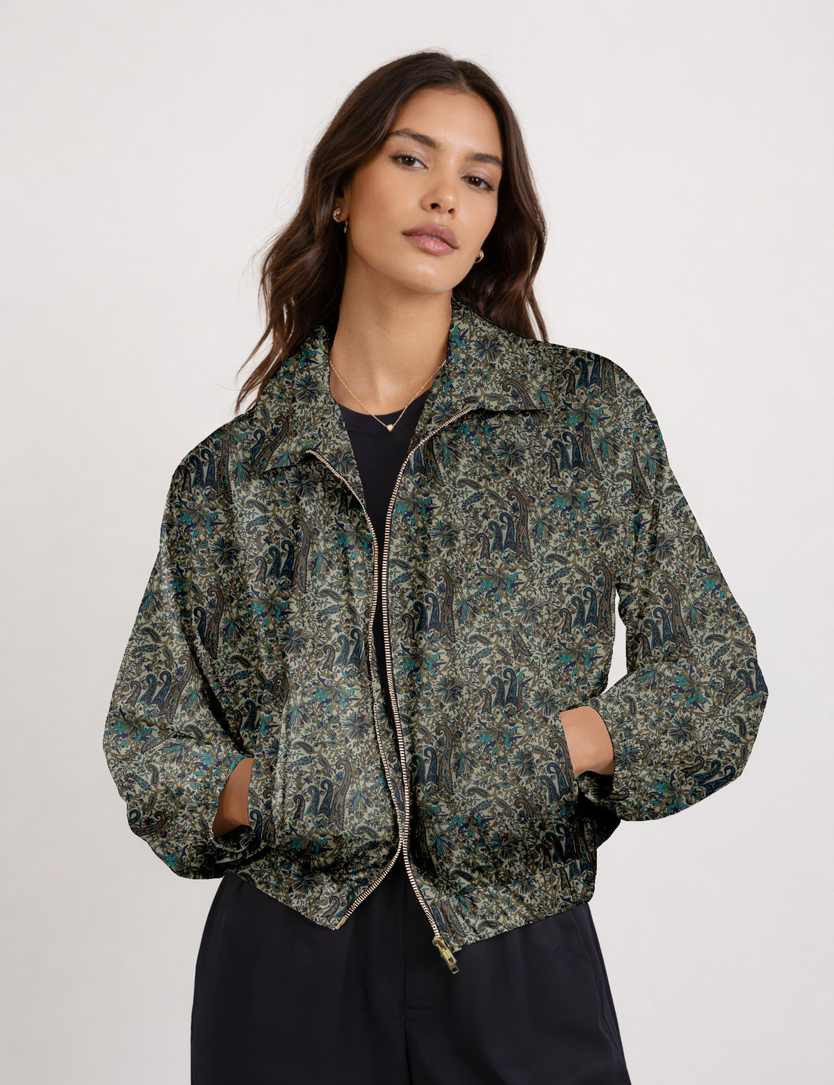 Woman wearing a yellow floral bomber jacket with front zipper, elastic cuffs, and side pockets, shown from front view