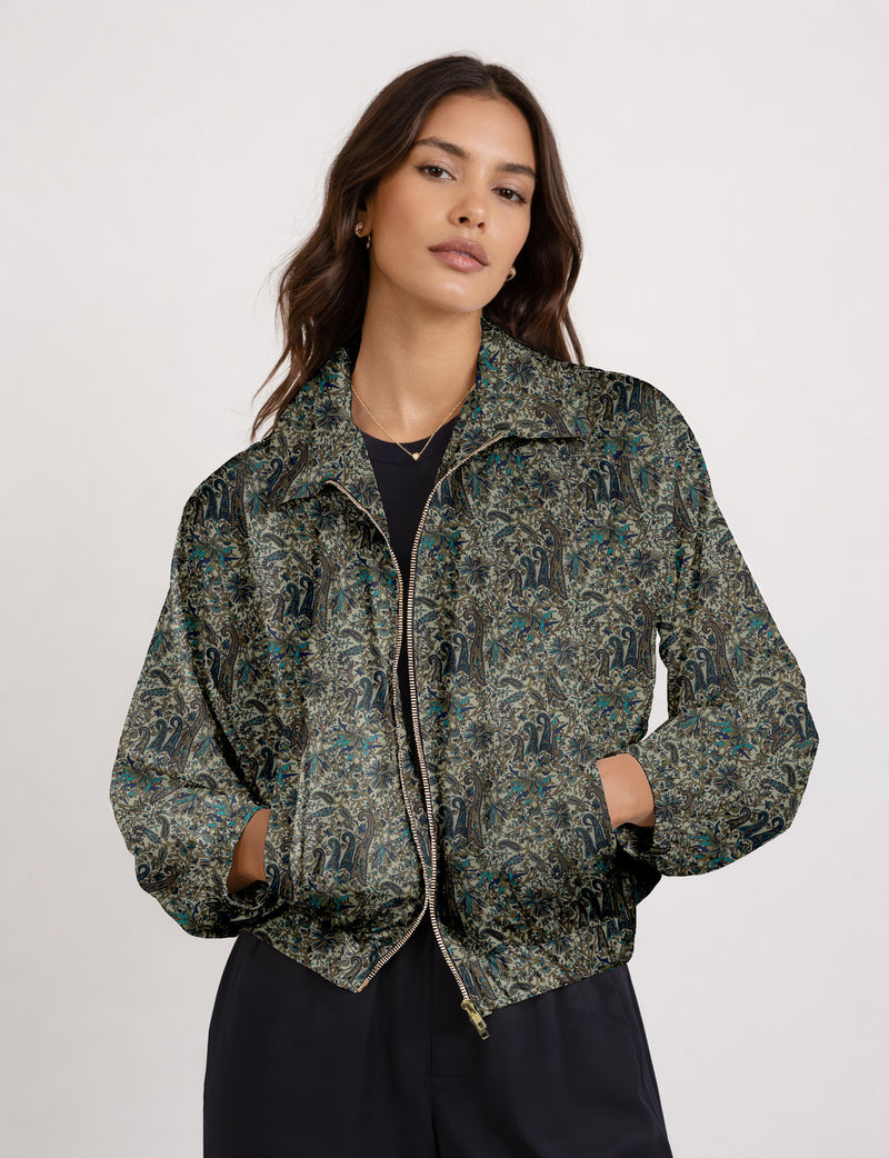 Woman wearing a yellow floral bomber jacket with front zipper, elastic cuffs, and side pockets, shown from front view
