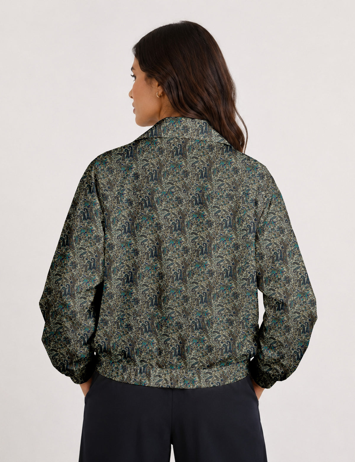 Brown floral bomber jacket with front zipper, elastic cuffs and hem, hanging on white hanger, red floral inner lining visible