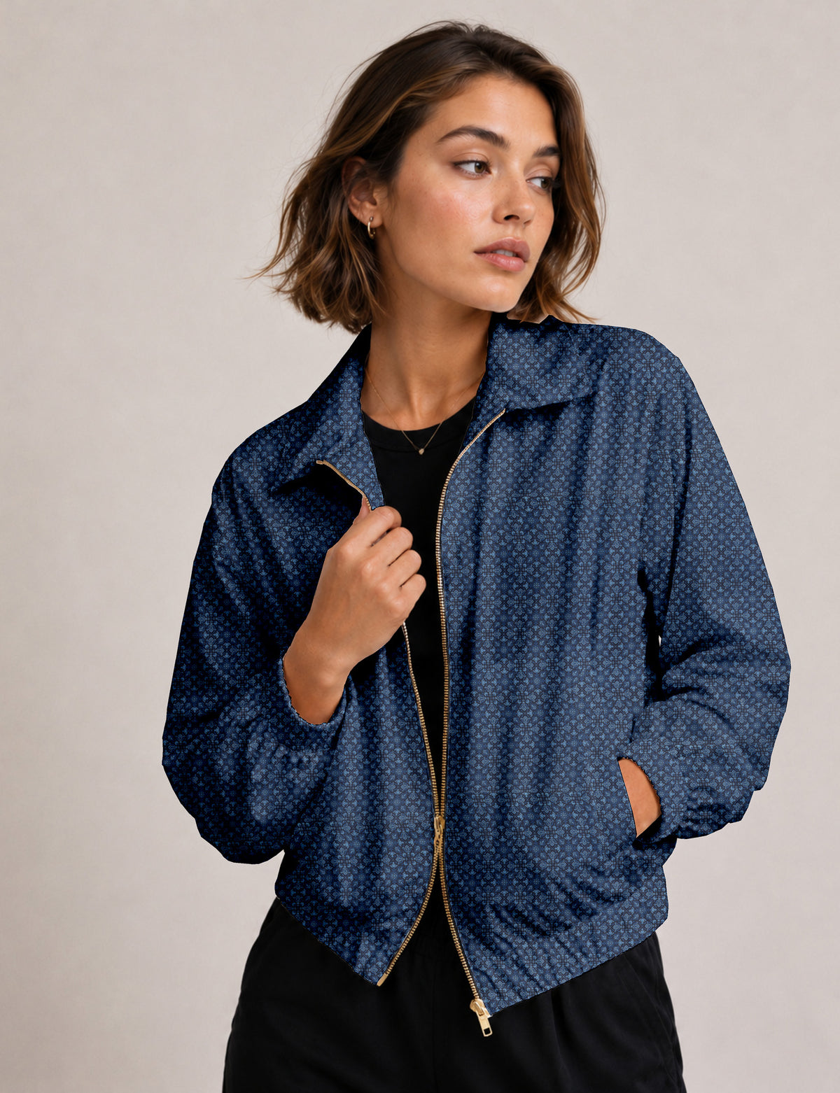 Woman wearing a yellow floral bomber jacket with front zipper, elastic cuffs, and side pockets, shown from front view