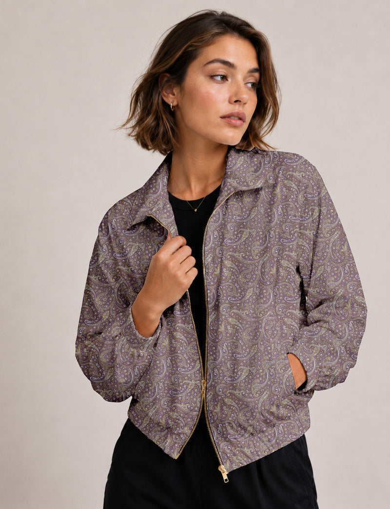 Brown floral bomber jacket with front zipper, elastic cuffs and hem, hanging on white hanger, red floral inner lining visible