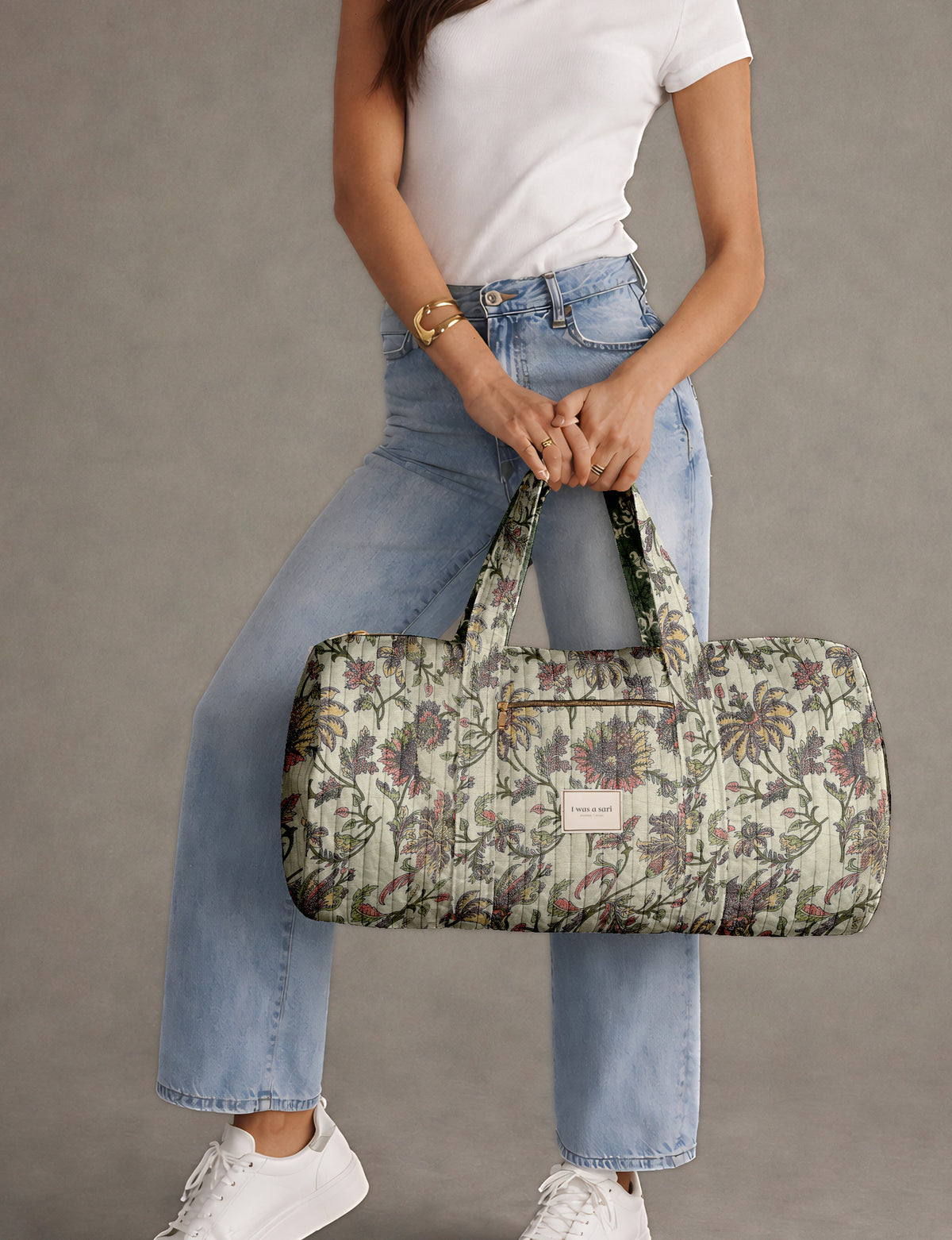 Brown paisley quilted bowling bag with dual handles, front zipper pocket, and "I was a sari" label on front side