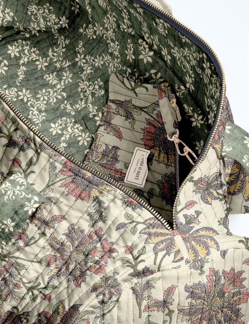 Brown paisley quilted bowling bag with dual handles, front zipper pocket, and "I was a sari" label on front side