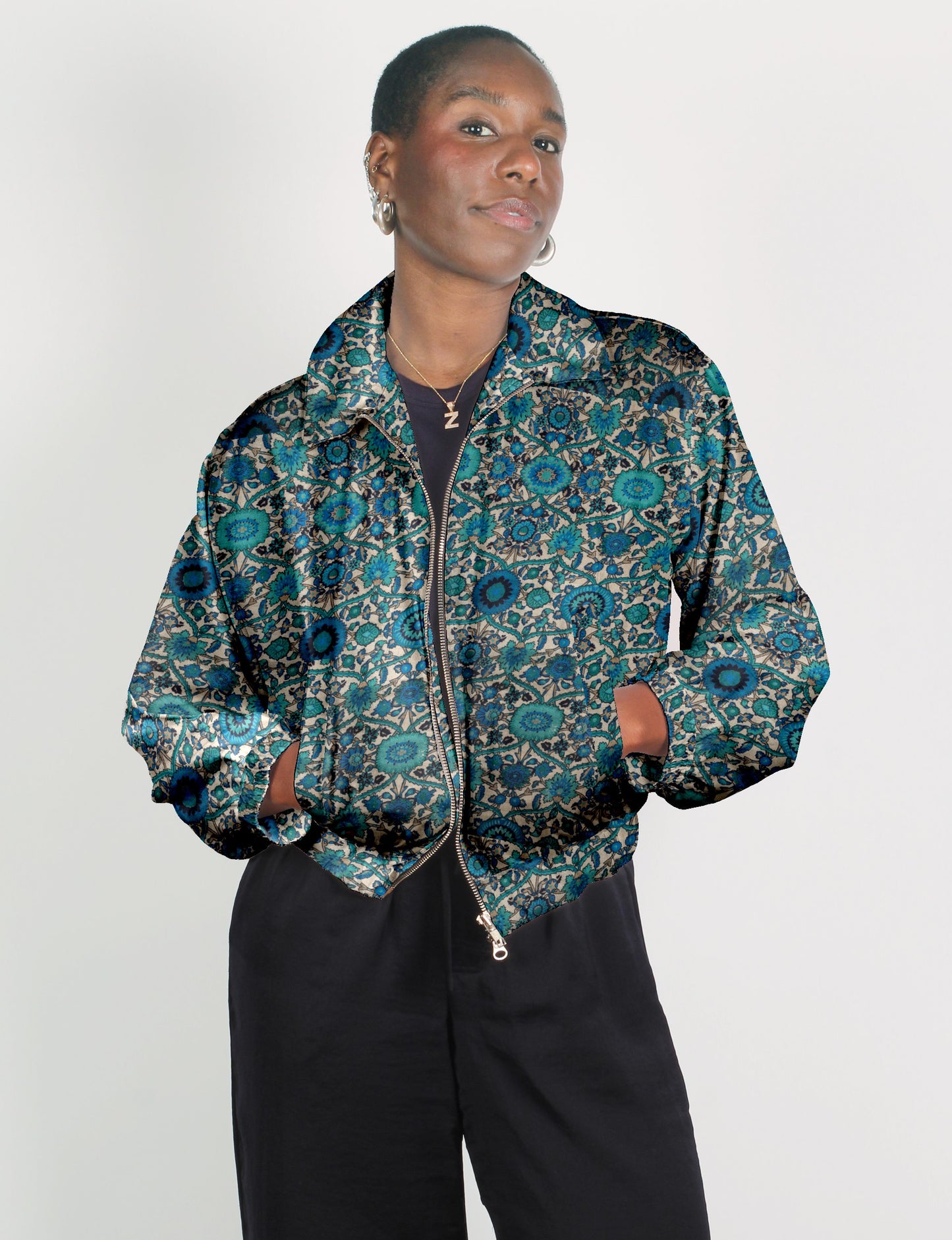 Upcycled Bomber Jacket made from recycled sari materials, featuring a cute cropped shape, elasticated hem and cuffs, and contrast sari print lining. Sustainable apparel promoting eco-friendly fashion and ethical clothing.