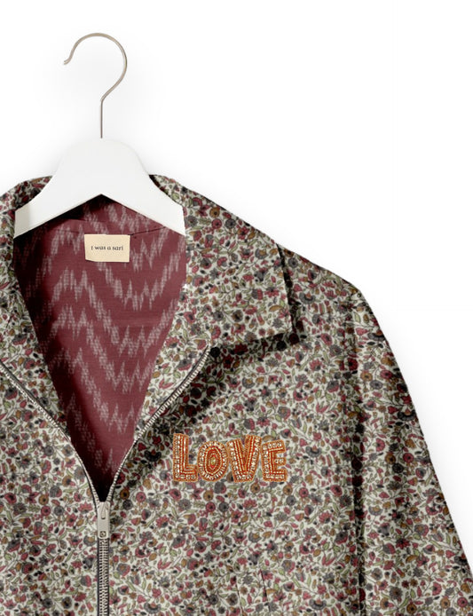 Love Bomber Jacket made from recycled fabric, featuring hand-stitched Aari embroidery. A unique piece of zero-waste clothing, part of the circular fashion movement. Designed with upcycled materials for a stylish yet environmentally friendly clothing choice.
