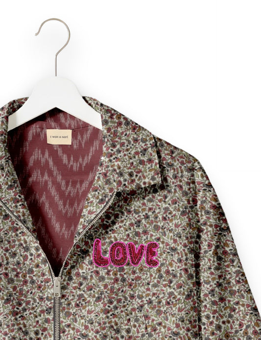 Love Bomber Jacket made from recycled fabric, featuring hand-stitched Aari embroidery. A unique piece of zero-waste clothing, part of the circular fashion movement. Designed with upcycled materials for a stylish yet environmentally friendly clothing choice.