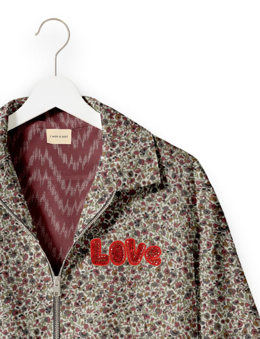 Love Bomber Jacket made from recycled fabric, featuring hand-stitched Aari embroidery. A unique piece of zero-waste clothing, part of the circular fashion movement. Designed with upcycled materials for a stylish yet environmentally friendly clothing choice.