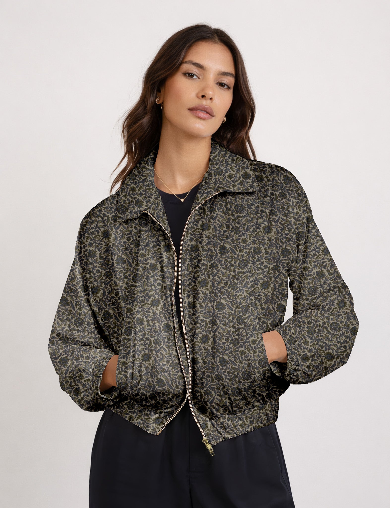 Woman wearing a yellow floral bomber jacket with front zipper, elastic cuffs, and side pockets, shown from front view