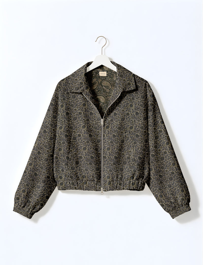 Brown floral bomber jacket with front zipper, elastic cuffs and hem, hanging on white hanger, red floral inner lining visible