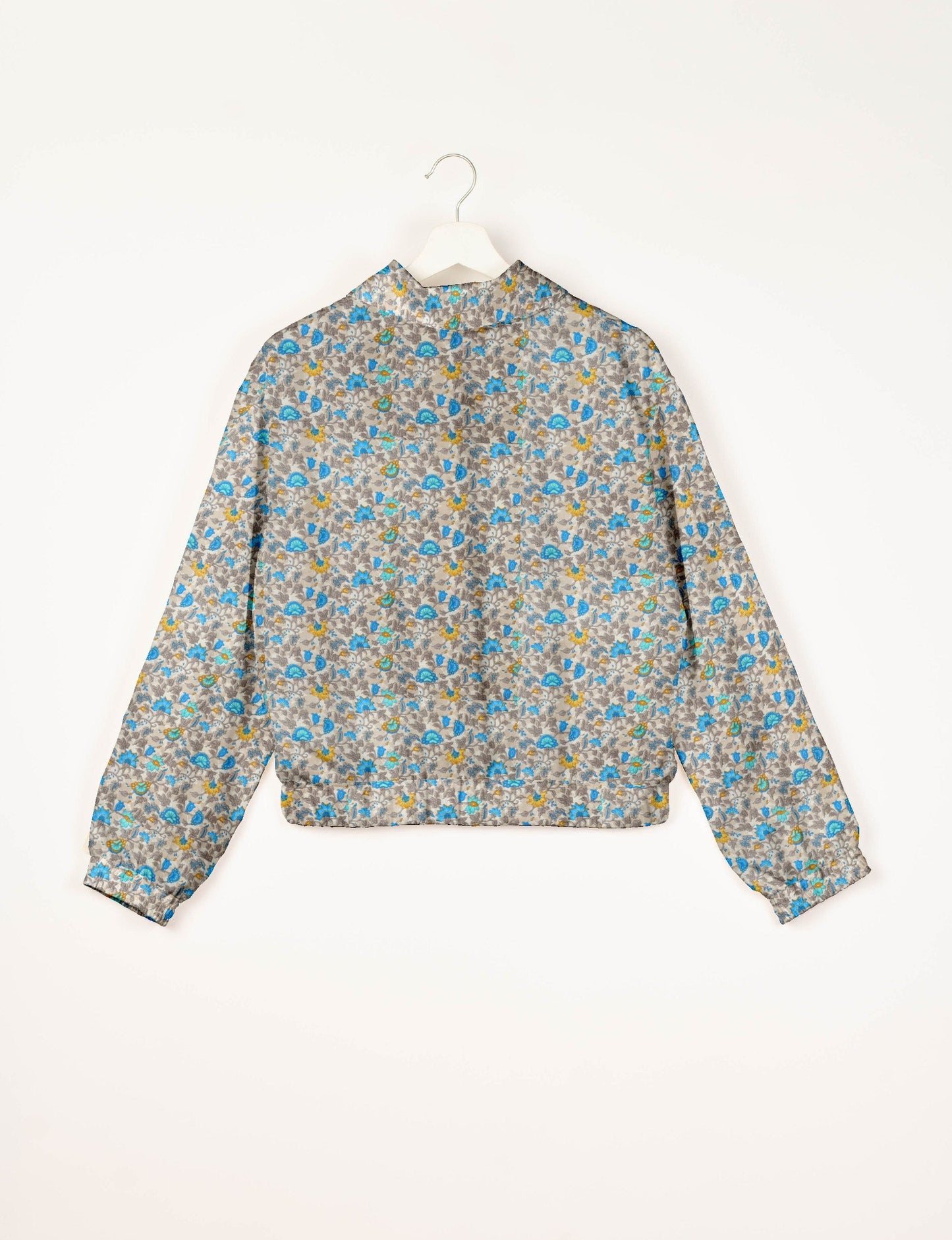 Upcycled Bomber Jacket made from recycled sari materials, featuring a cute cropped shape, elasticated hem and cuffs, and contrast sari print lining. Sustainable apparel promoting eco-friendly fashion and ethical clothing.