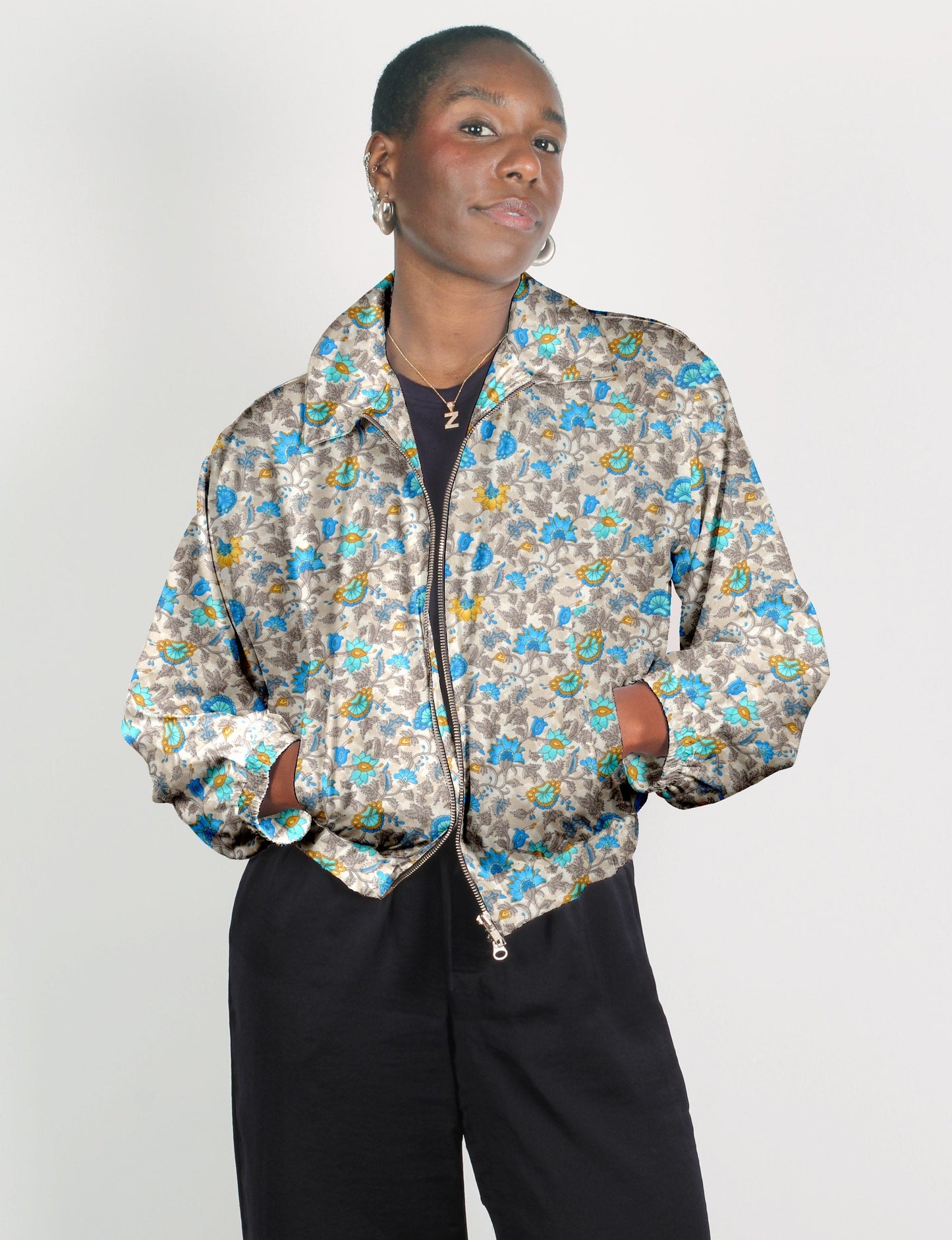 Upcycled Bomber Jacket made from recycled sari materials, featuring a cute cropped shape, elasticated hem and cuffs, and contrast sari print lining. Sustainable apparel promoting eco-friendly fashion and ethical clothing.