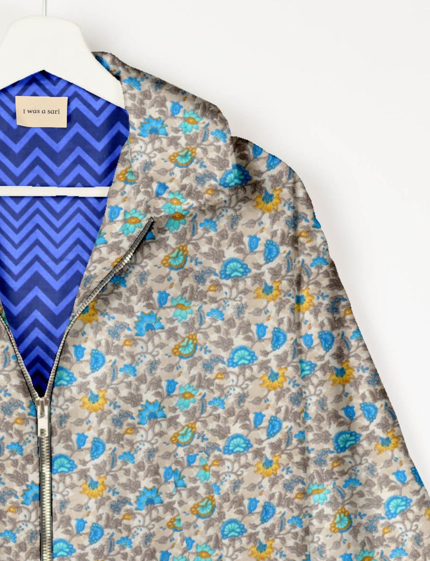 Upcycled Bomber Jacket made from recycled sari materials, featuring a cute cropped shape, elasticated hem and cuffs, and contrast sari print lining. Sustainable apparel promoting eco-friendly fashion and ethical clothing.