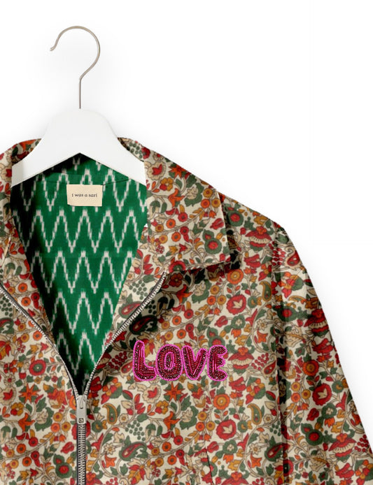 Love Bomber Jacket made from recycled fabric, featuring hand-stitched Aari embroidery. A unique piece of zero-waste clothing, part of the circular fashion movement. Designed with upcycled materials for a stylish yet environmentally friendly clothing choice.