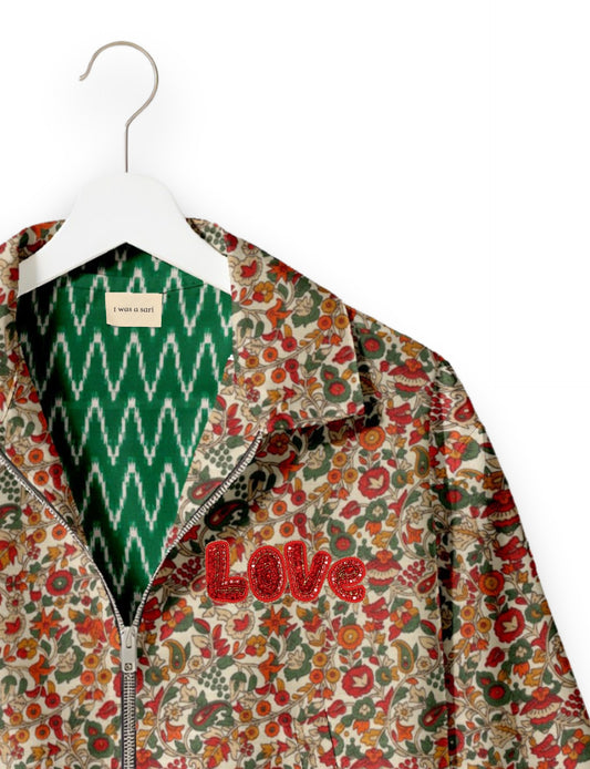 Love Bomber Jacket made from recycled fabric, featuring hand-stitched Aari embroidery. A unique piece of zero-waste clothing, part of the circular fashion movement. Designed with upcycled materials for a stylish yet environmentally friendly clothing choice.