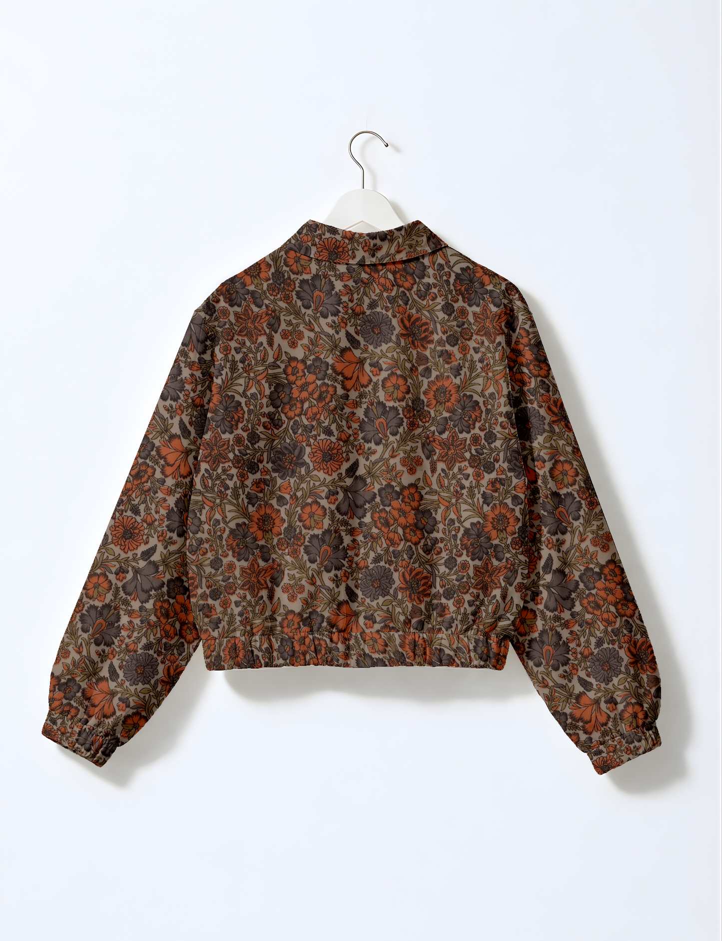 Women's cropped bomber jacket with twin metallic front zippers, welt pockets, elasticated hem and cuffs, and contrast sari print lining.