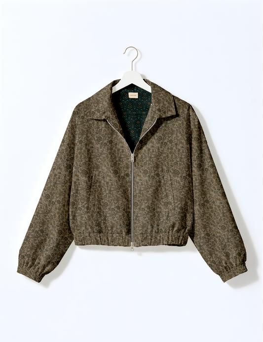 Women's cropped bomber jacket with twin metallic front zippers, welt pockets, elasticated hem and cuffs, and contrast sari print lining.