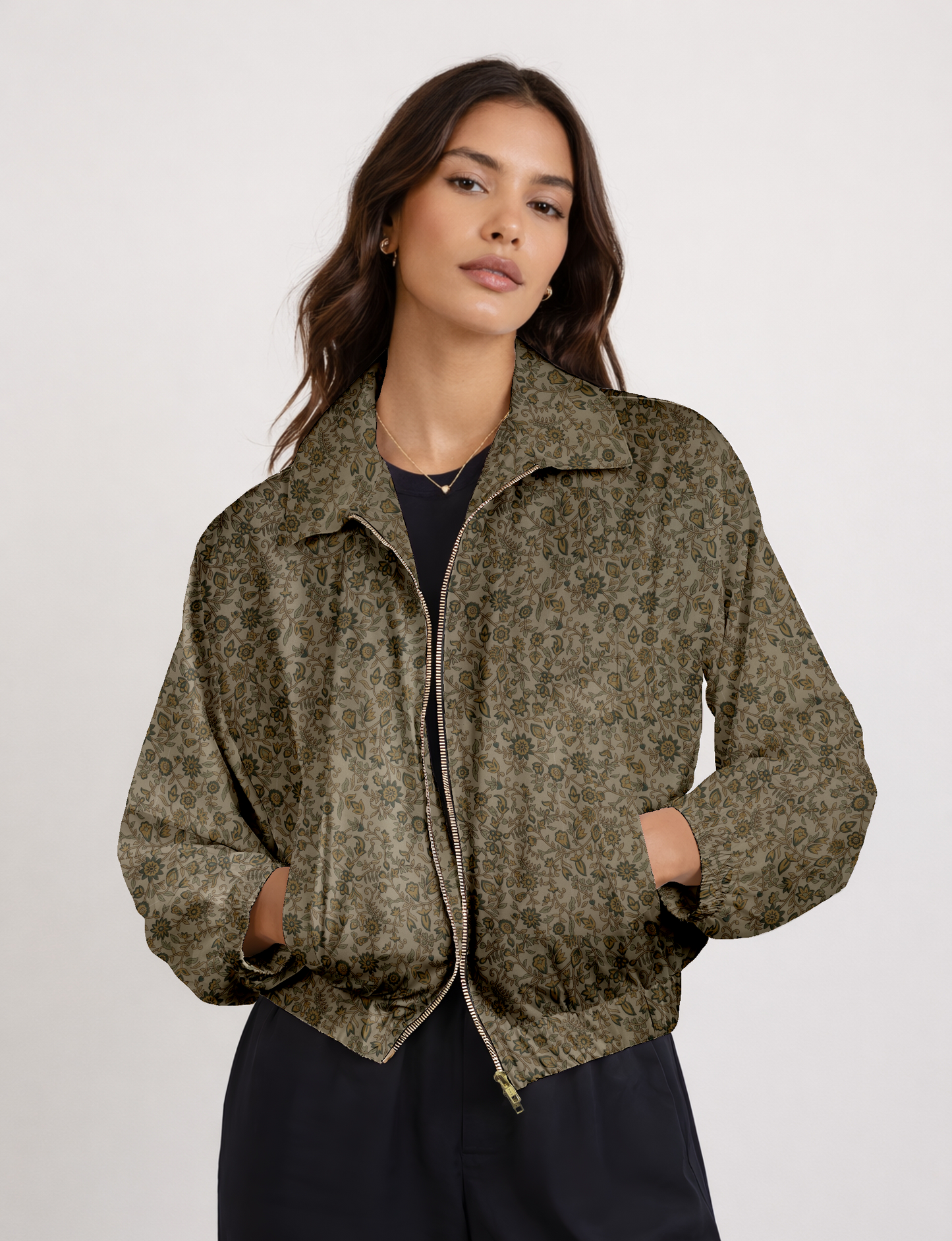 Women's cropped bomber jacket with twin metallic front zippers, welt pockets, elasticated hem and cuffs, and contrast sari print lining.
