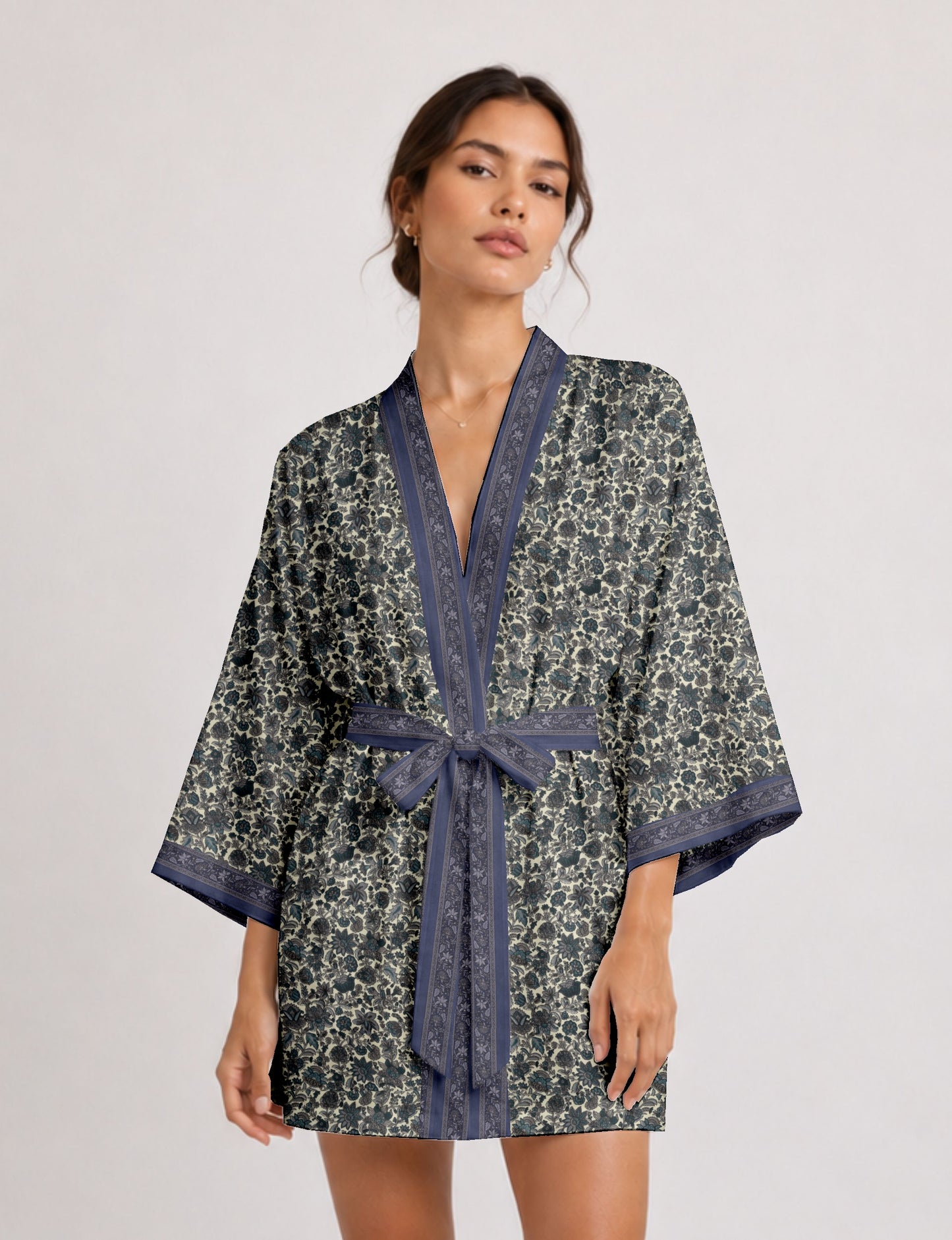 Short kimono robe with wrap front, V-neckline, wide sleeves, waist tie, and concealed skort detail.