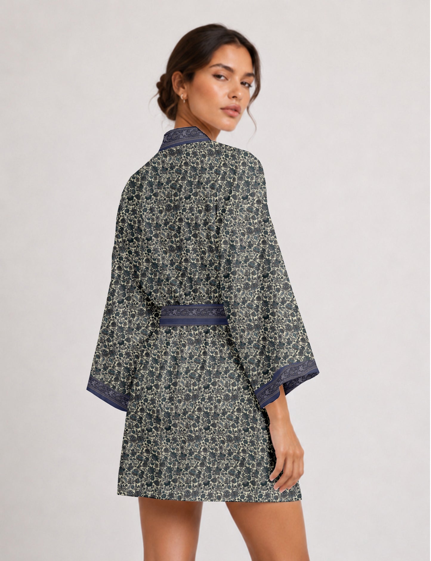 Short kimono robe with wrap front, V-neckline, wide sleeves, waist tie, and concealed skort detail.