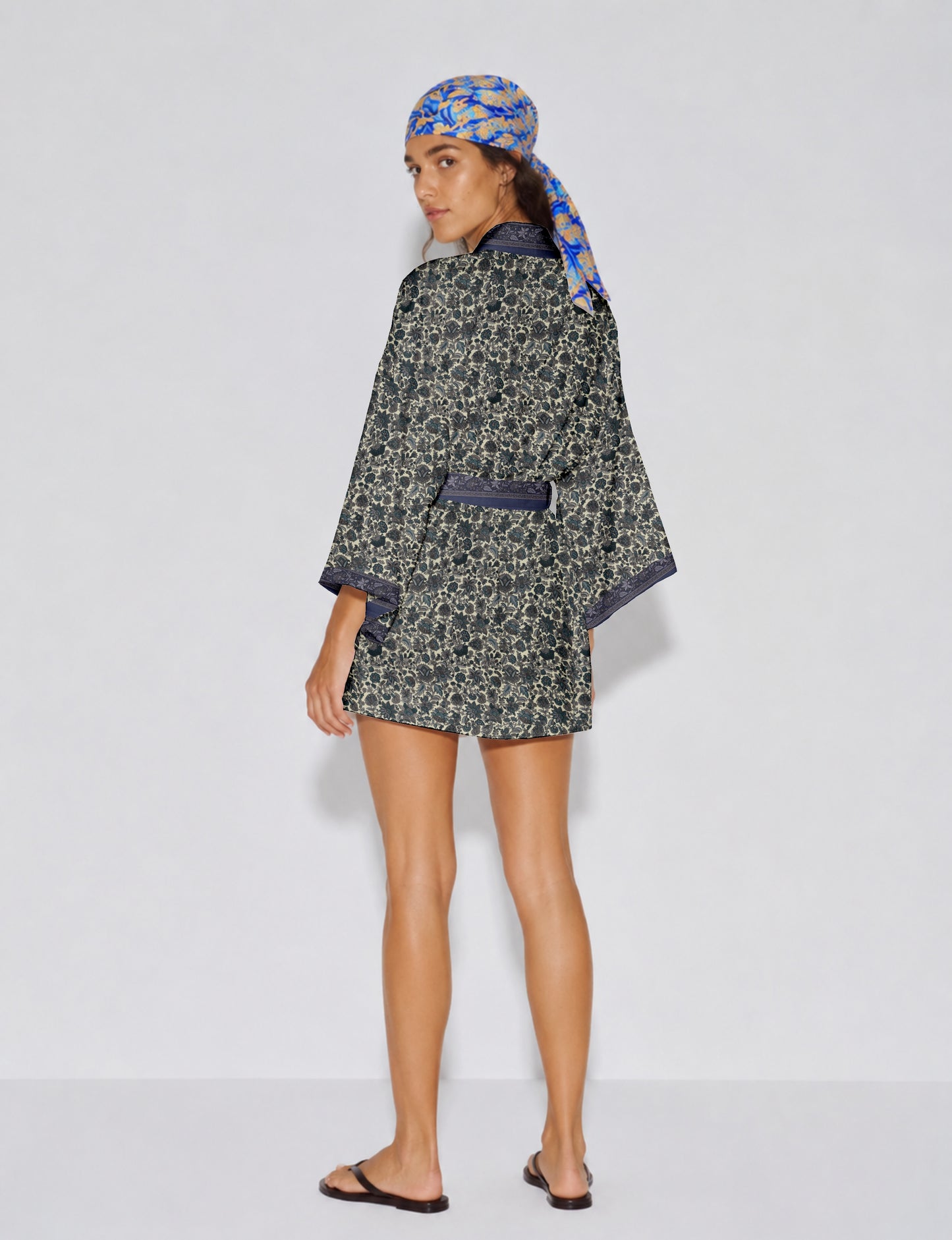 Short kimono robe with wrap front, V-neckline, wide sleeves, waist tie, and concealed skort detail.