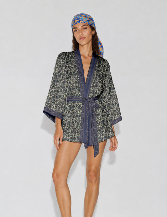 Short kimono robe with wrap front, V-neckline, wide sleeves, waist tie, and concealed skort detail.
