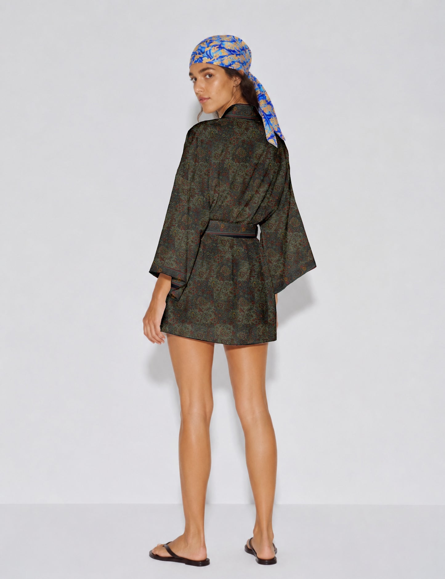 Short kimono robe with wrap front, V-neckline, wide sleeves, waist tie, and concealed skort detail.