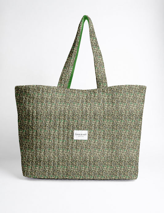 Quilted yellow tropical patterned beach bag with long handles and white label reading "I was a sari" front view