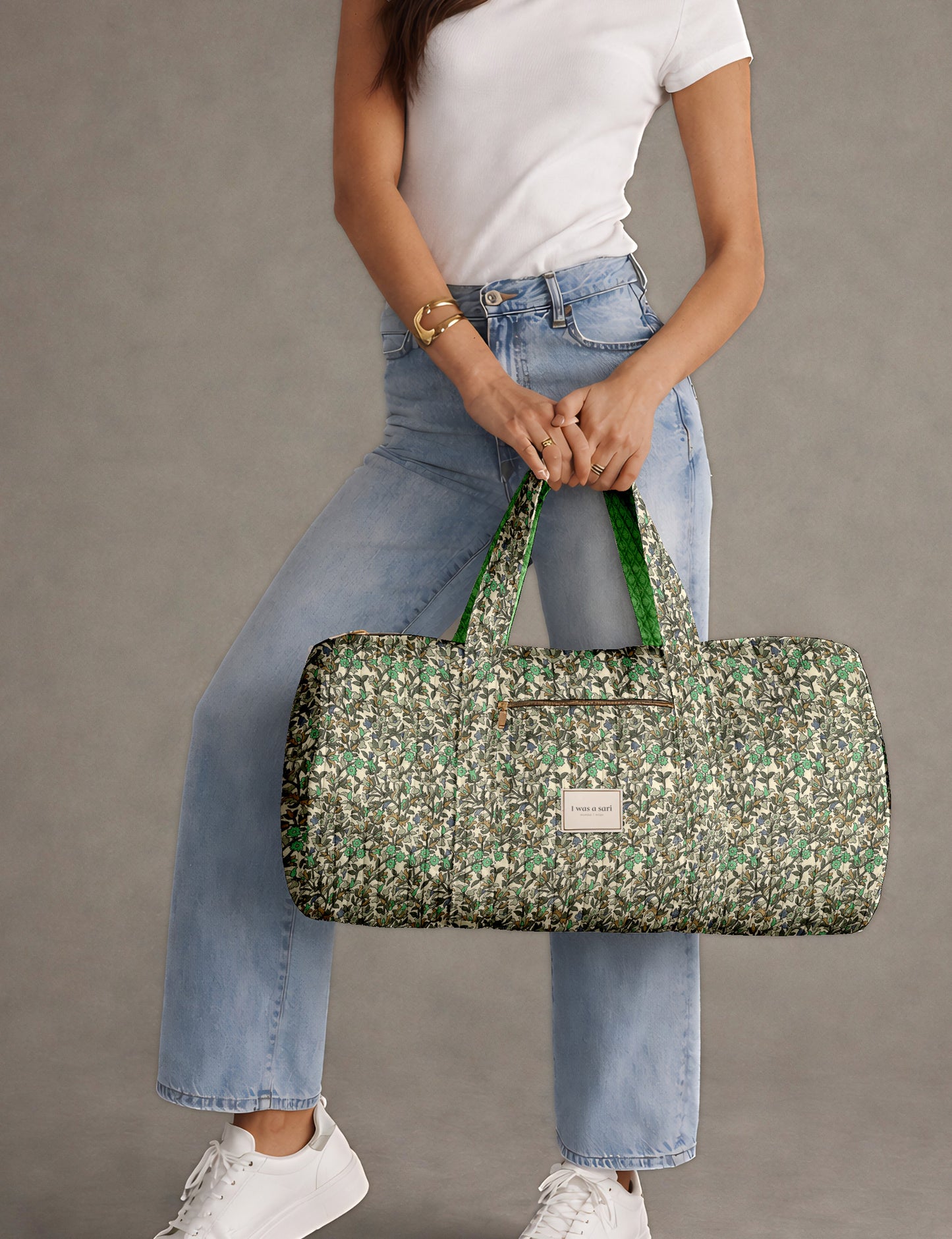 Brown paisley quilted bowling bag with dual handles, front zipper pocket, and "I was a sari" label on front side
