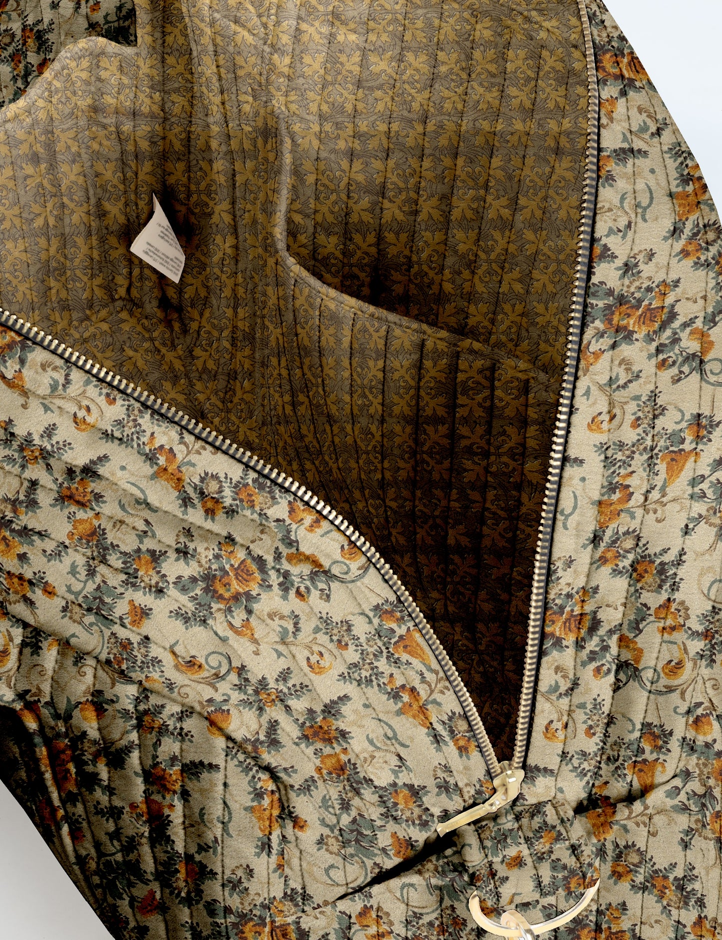 Beige quilted duffle bag with tropical floral print, gold zipper, and patterned interior lining shown open