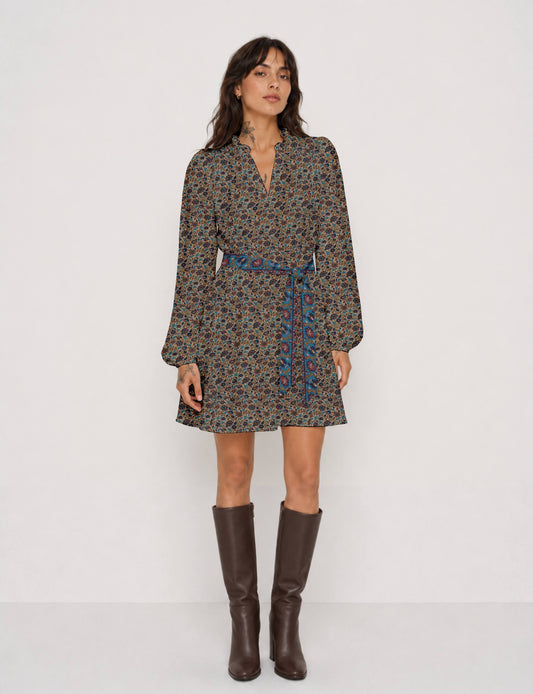 Swing dress with detachable tie belt, gathered ruffle neckline, full-length voluminous sleeves, elastic cuffs, and relaxed A-line silhouette in an above-knee length.