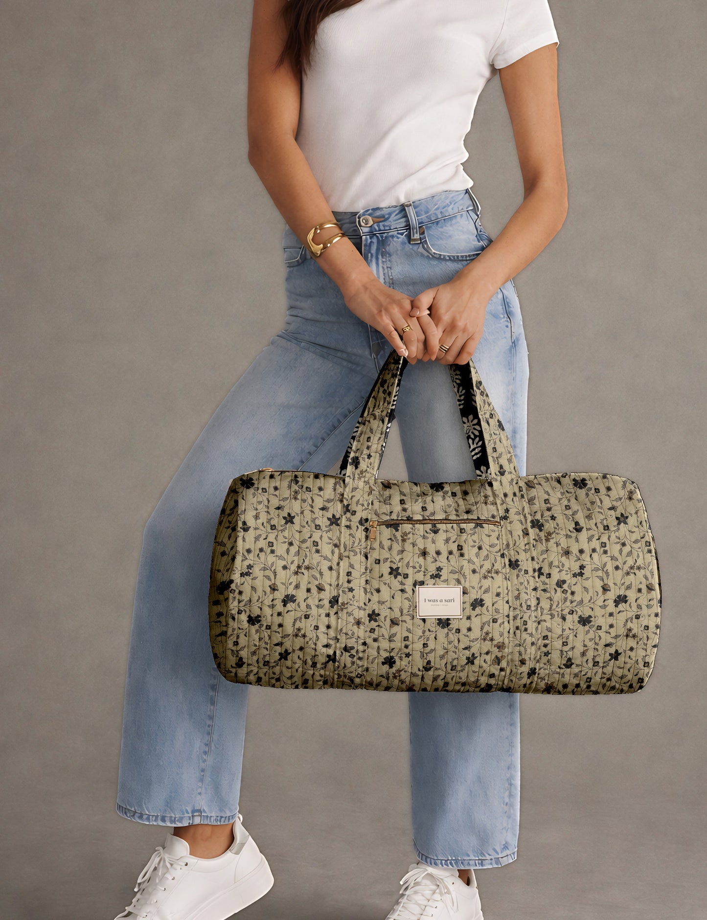 Brown paisley quilted bowling bag with dual handles, front zipper pocket, and "I was a sari" label on front side