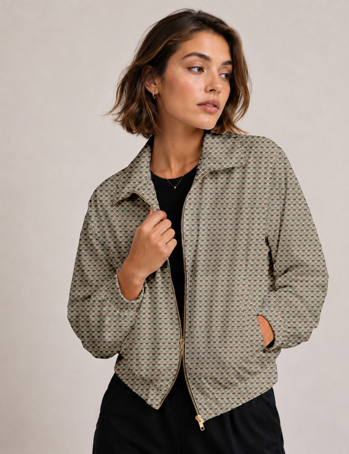 Woman wearing a yellow floral bomber jacket with front zipper, elastic cuffs, and side pockets, shown from front view