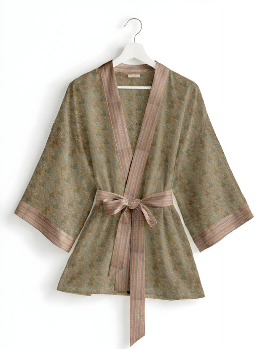 Short kimono robe with wrap front, V-neckline, wide sleeves, waist tie, and concealed skort detail.