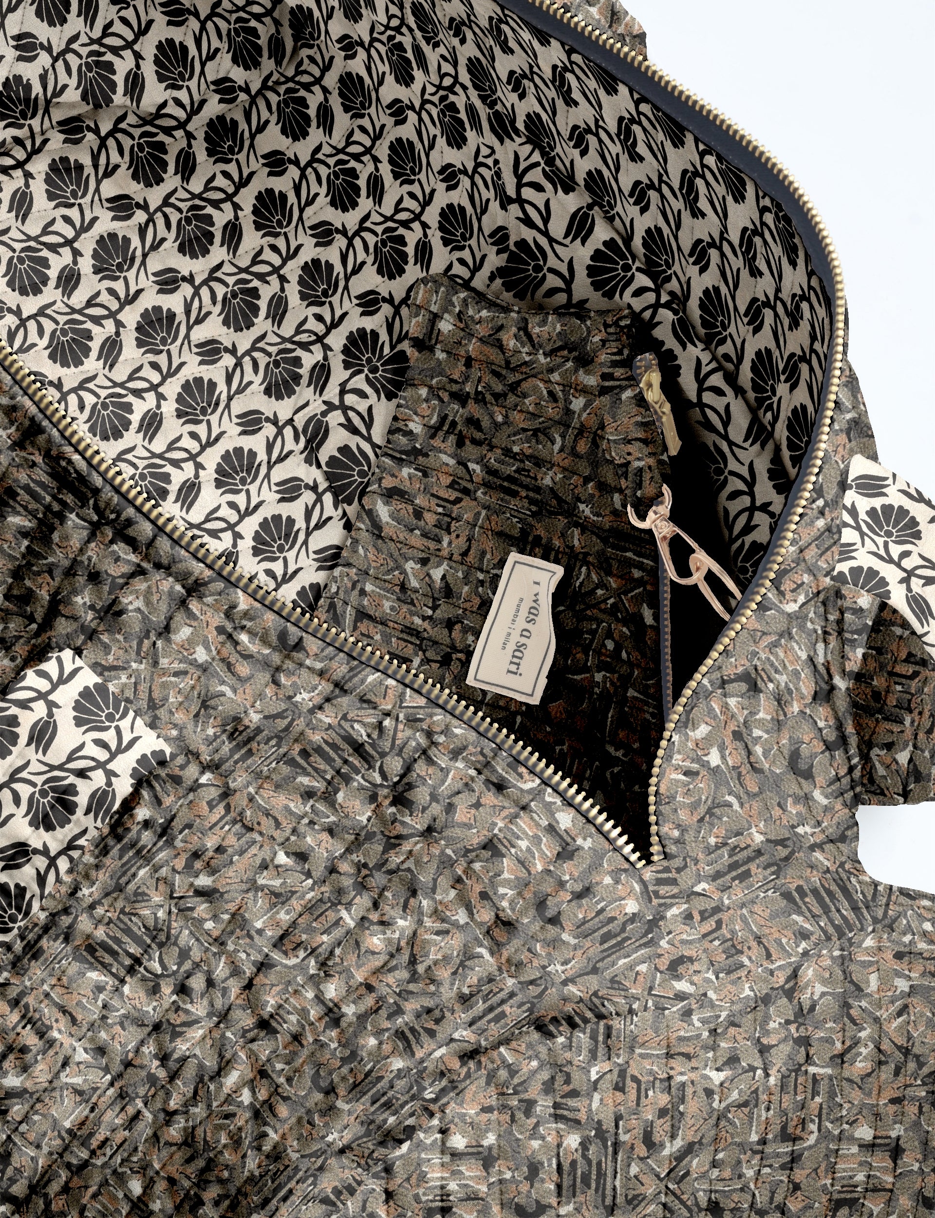 Quilted bowling bag with black, brown, and gray abstract pattern, gold zipper, and black floral interior lining