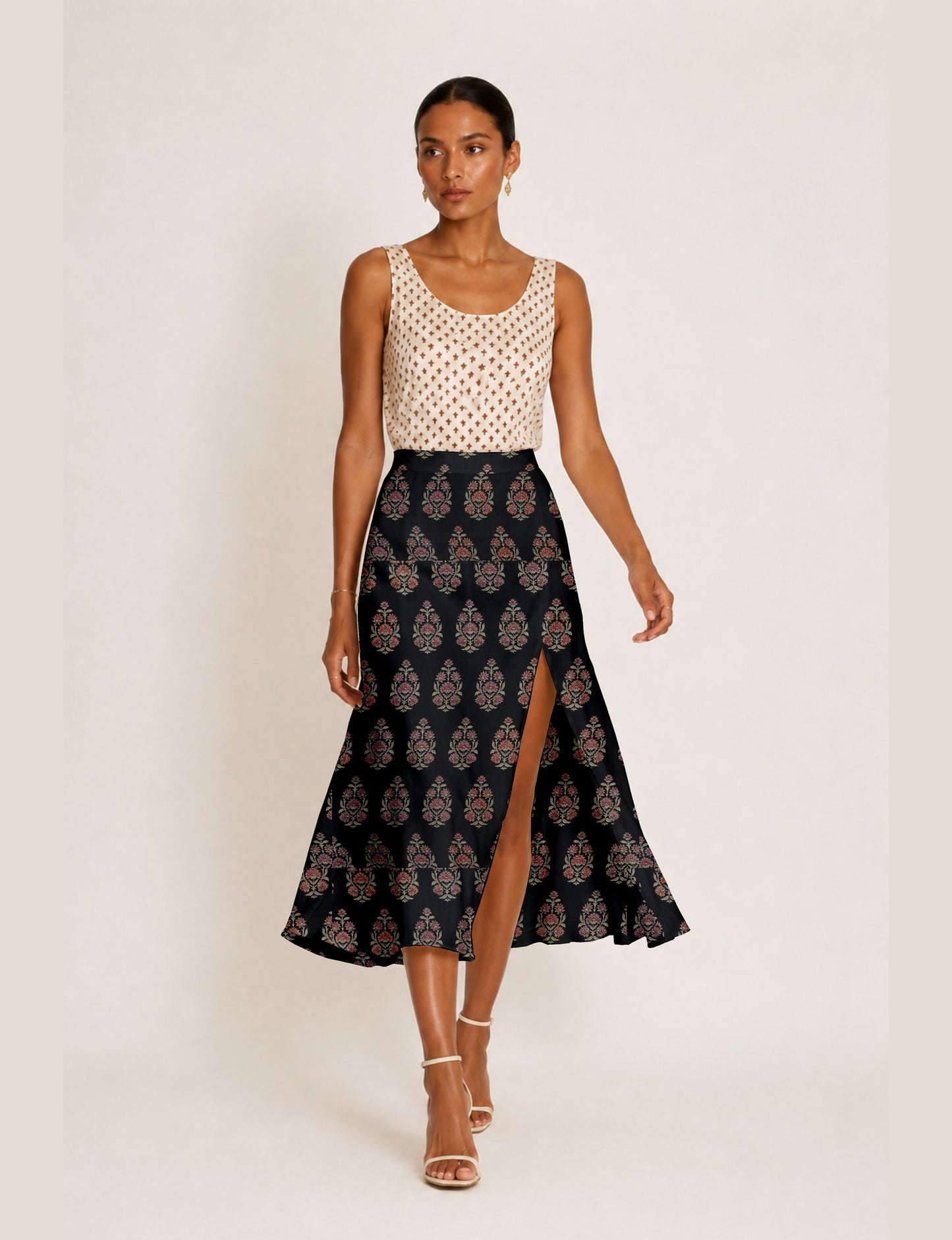 Midi A-line skirt with front slit, fitted waistband, concealed side closure, and below mid-calf length silhouette.