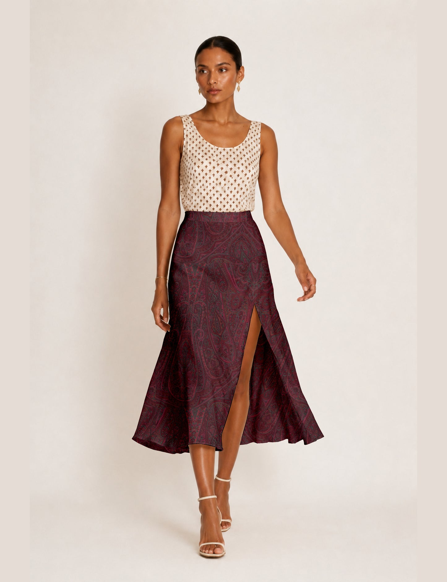 Midi A-line skirt with front slit, fitted waistband, concealed side closure, and below mid-calf length silhouette.