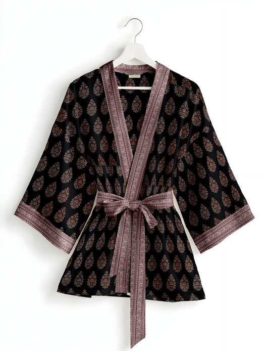 Short kimono robe with wrap front, V-neckline, wide sleeves, waist tie, and concealed skort detail.