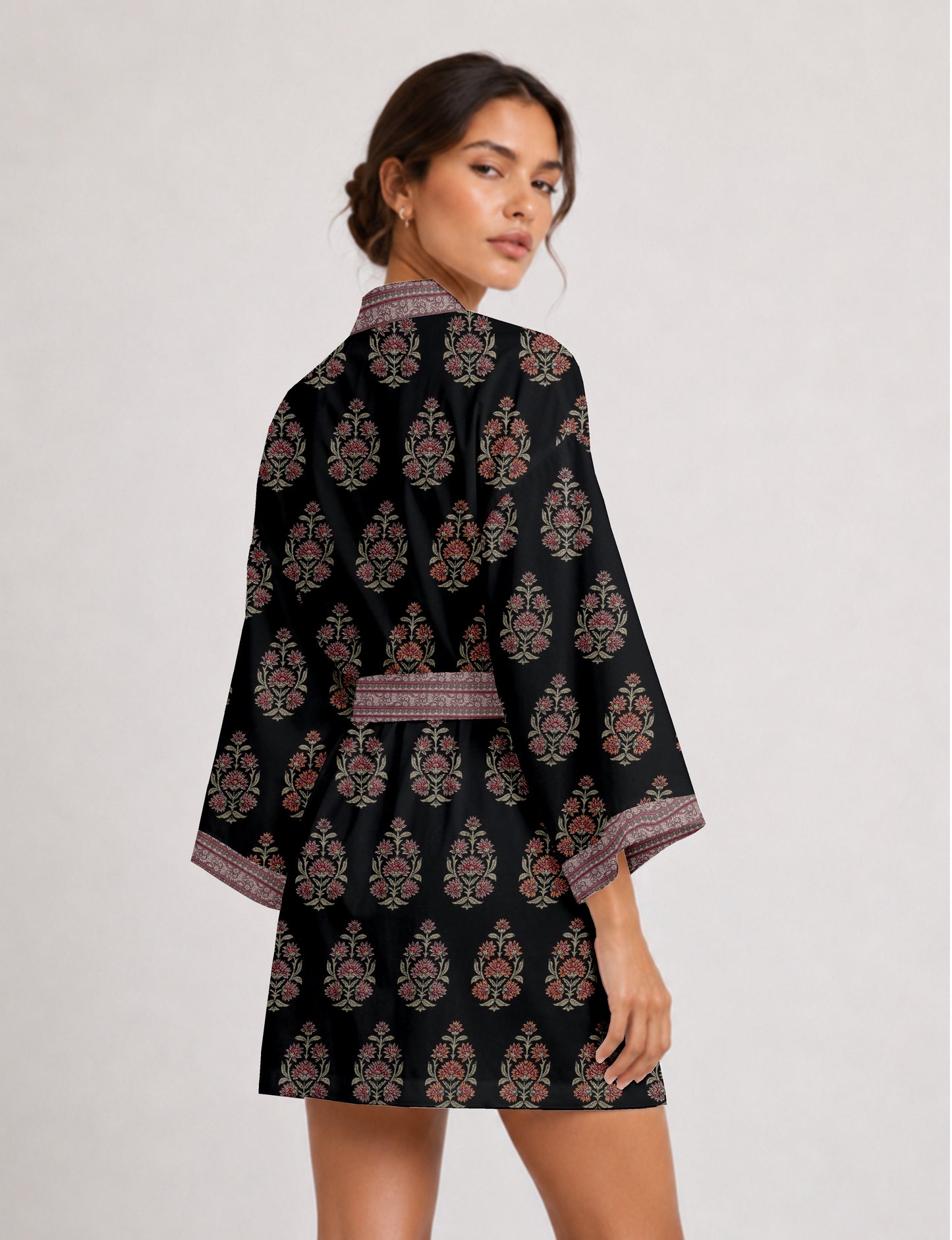 Short kimono robe with wrap front, V-neckline, wide sleeves, waist tie, and concealed skort detail.