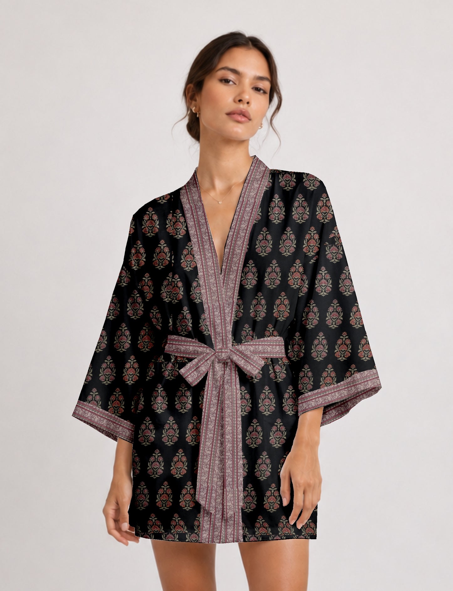 Short kimono robe with wrap front, V-neckline, wide sleeves, waist tie, and concealed skort detail.