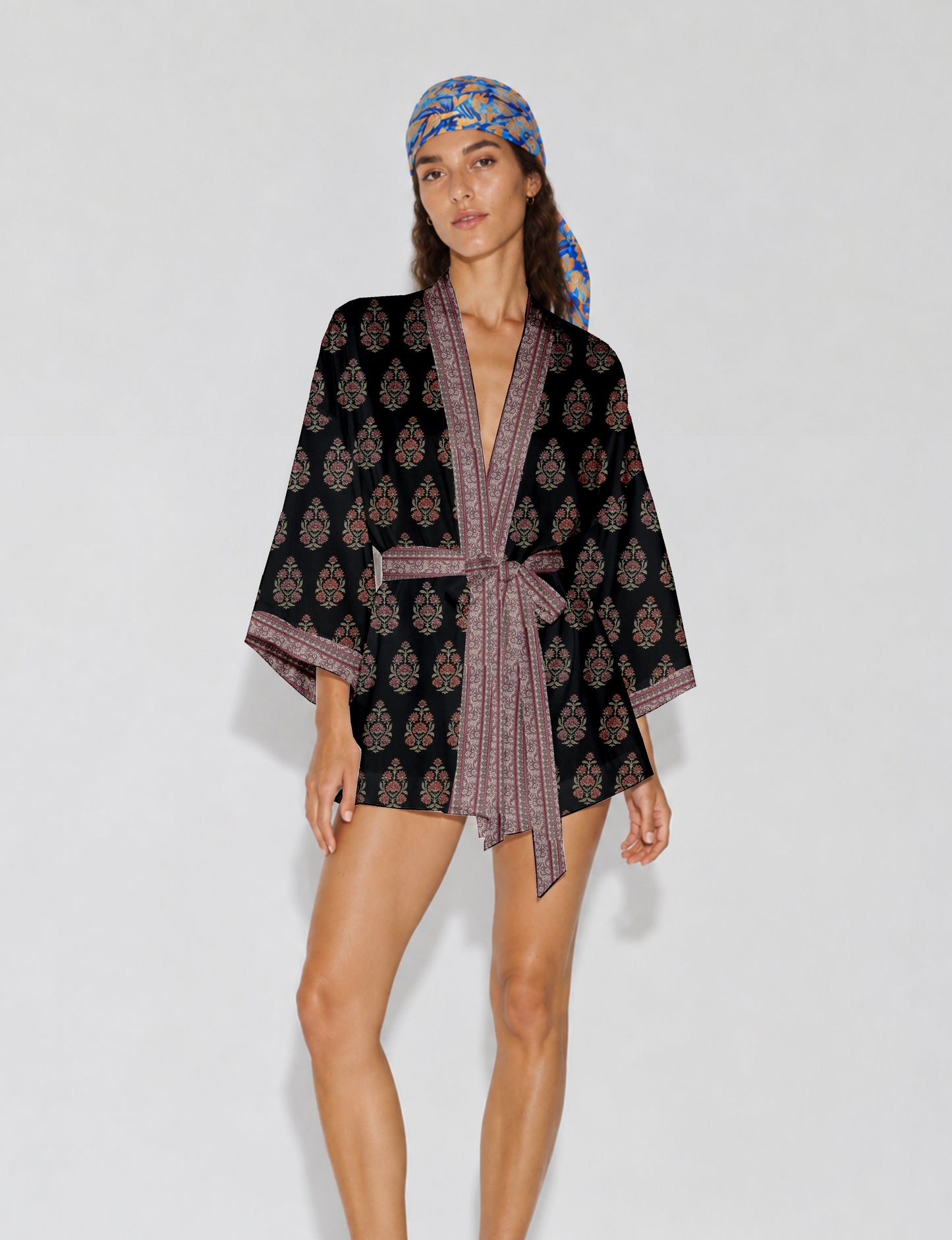 Short kimono robe with wrap front, V-neckline, wide sleeves, waist tie, and concealed skort detail.