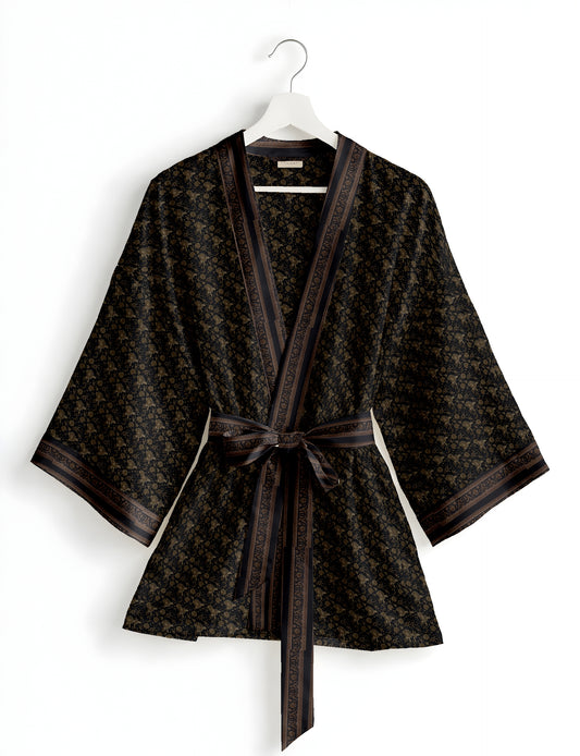Short kimono robe with wrap front, V-neckline, wide sleeves, waist tie, and concealed skort detail.